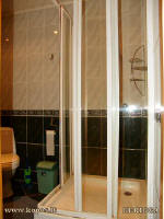 A separate bathroom with a washbasin, shower and WC.